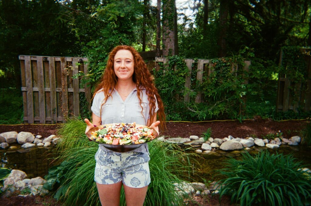 victoria holding a salad dish at a party